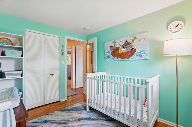 4860 Downing Dr, Columbus, OH 43232 - bedroom featuring wood finished floors, a closet, and a nursery area