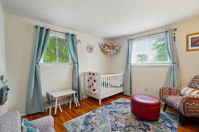 4860 Downing Dr, Columbus, OH 43232 - bedroom featuring multiple windows and wood finished floors