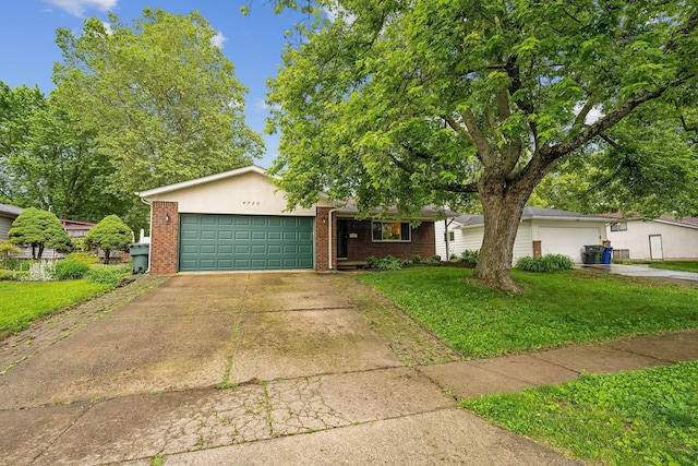4750 Manitoba Ct, Columbus, OH 43229 - single story home with a front lawn, a garage, brick siding, and driveway