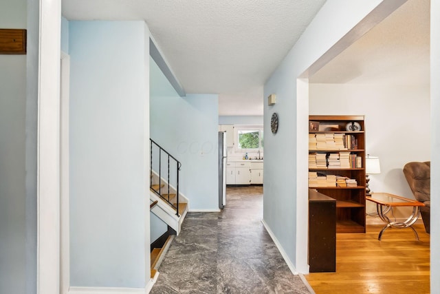 4750 Manitoba Ct, Columbus, OH 43229 - hallway featuring stairway and a textured ceiling