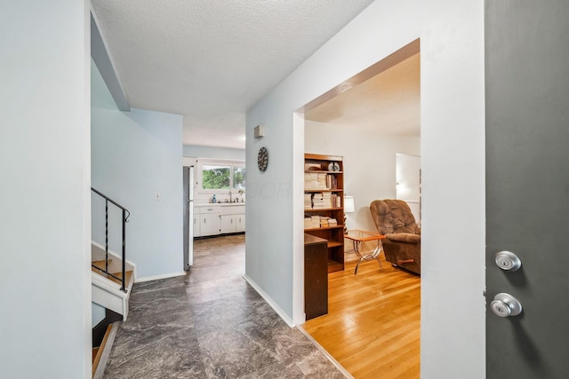 4750 Manitoba Ct, Columbus, OH 43229 - hall featuring stairway and a textured ceiling