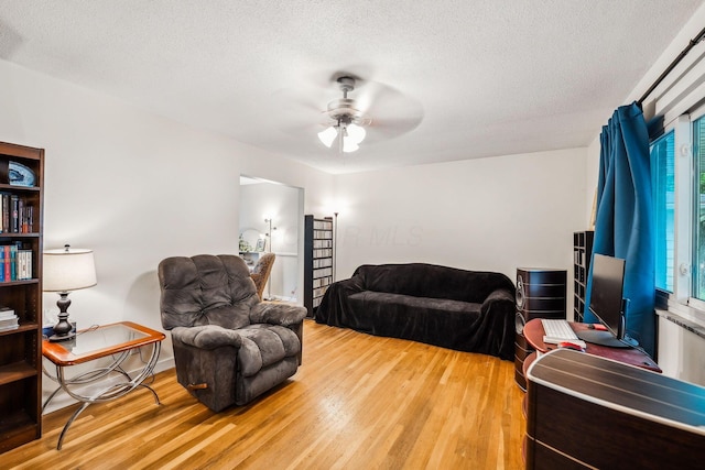 4750 Manitoba Ct, Columbus, OH 43229 - living room with light wood-style floors, ceiling fan, and a textured ceiling