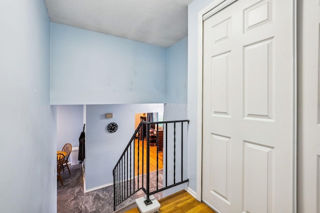4750 Manitoba Ct, Columbus, OH 43229 - stairs with a textured ceiling and wood finished floors