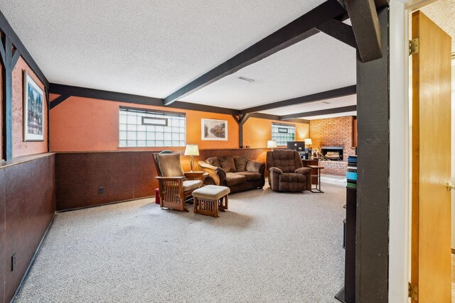4750 Manitoba Ct, Columbus, OH 43229 - living room with beam ceiling, carpet floors, a textured ceiling, a brick fireplace, and a wainscoted wall