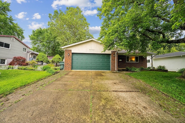 4750 Manitoba Ct, Columbus, OH 43229 - view of front of home featuring an attached garage, brick siding, a front lawn, and concrete driveway