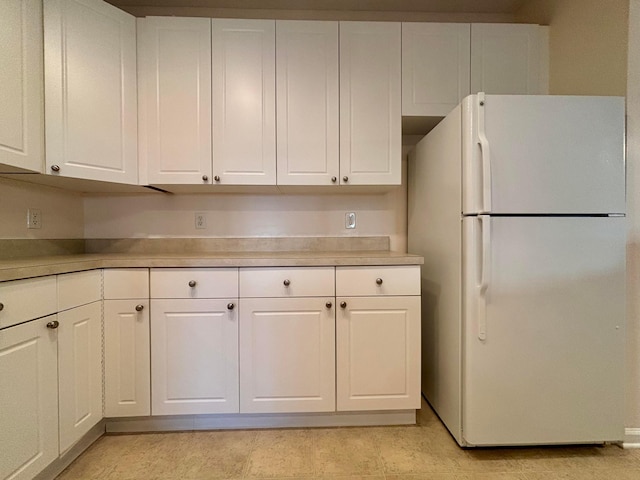 3839 Carberry Dr, Dublin, OH 43016 - kitchen featuring freestanding refrigerator, light countertops, and white cabinets