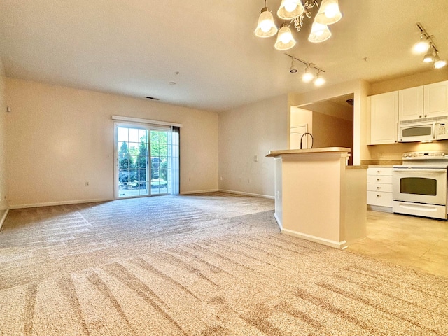 3839 Carberry Dr, Dublin, OH 43016 - kitchen featuring white appliances, rail lighting, a chandelier, and white cabinets