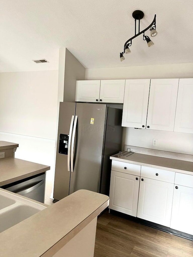 8061 Cranes Crossing Dr, Lewis Center, OH 43035 - kitchen featuring stainless steel fridge, white cabinetry, dark wood finished floors, light countertops, and track lighting