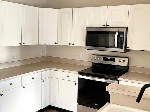 8061 Cranes Crossing Dr, Lewis Center, OH 43035 - kitchen with appliances with stainless steel finishes and white cabinetry