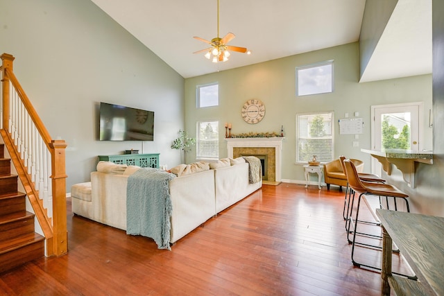 7029 Post Preserve Blvd, Dublin, OH 43016 - living area with high vaulted ceiling, ceiling fan, wood finished floors, a fireplace, and stairway