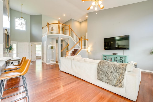 7029 Post Preserve Blvd, Dublin, OH 43016 - living area featuring high vaulted ceiling, ceiling fan, wood finished floors, stairway, and recessed lighting