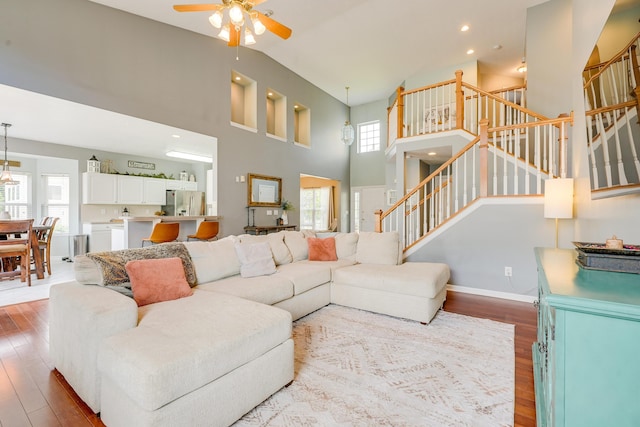 7029 Post Preserve Blvd, Dublin, OH 43016 - living room with wood finished floors, stairs, ceiling fan, and high vaulted ceiling