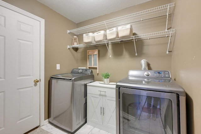 7029 Post Preserve Blvd, Dublin, OH 43016 - laundry room featuring washer and clothes dryer, light marble finish flooring, and cabinet space