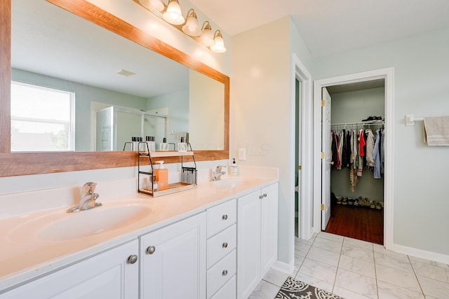7029 Post Preserve Blvd, Dublin, OH 43016 - bathroom with a stall shower, double vanity, a walk in closet, and marble finish floors