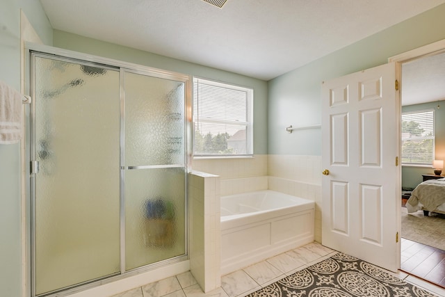 7029 Post Preserve Blvd, Dublin, OH 43016 - ensuite bathroom with a garden tub, a shower stall, and marble look tile flooring