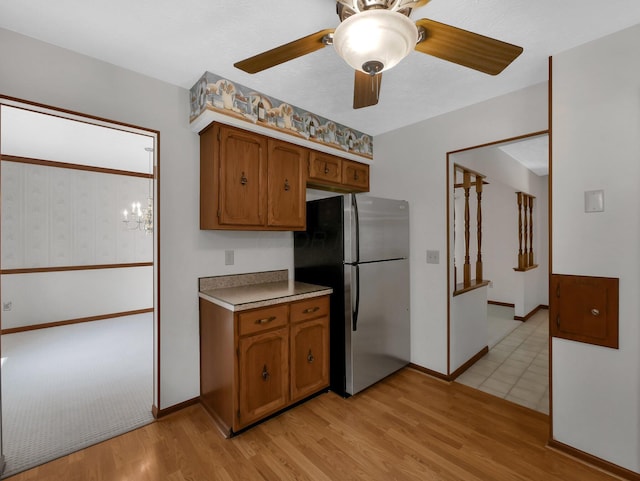 1380 Hanbury Ct, Gahanna, OH 43230 - kitchen featuring freestanding refrigerator, brown cabinetry, light wood-type flooring, and ceiling fan