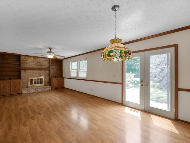 1380 Hanbury Ct, Gahanna, OH 43230 - unfurnished living room with crown molding, wood finished floors, a textured ceiling, a ceiling fan, and french doors