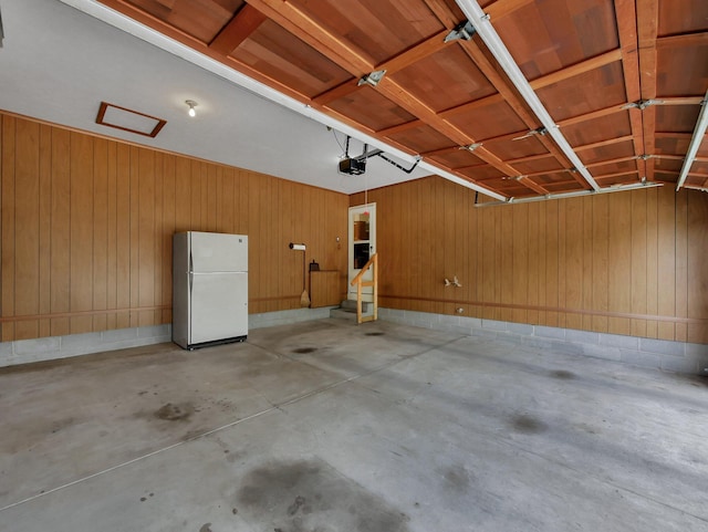 1380 Hanbury Ct, Gahanna, OH 43230 - garage with freestanding refrigerator, a garage door opener, and wood walls