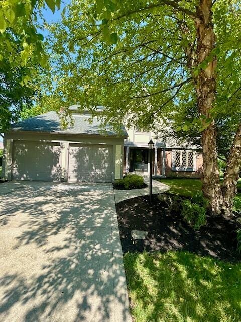 6978 Ernest Way, Dublin, OH 43017 - obstructed view of property featuring driveway and an attached garage