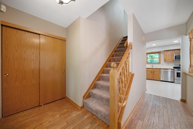 6978 Ernest Way, Dublin, OH 43017 - stairs with hardwood / wood-style floors and baseboards
