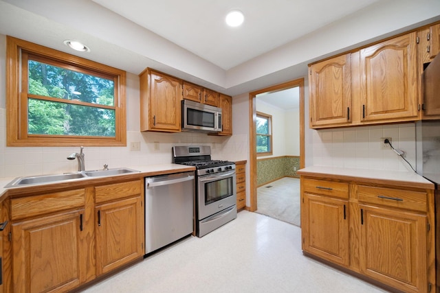 6978 Ernest Way, Dublin, OH 43017 - kitchen featuring appliances with stainless steel finishes, light flooring, decorative backsplash, light countertops, and brown cabinetry