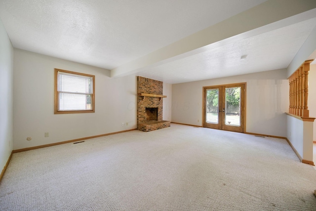 6978 Ernest Way, Dublin, OH 43017 - unfurnished living room with french doors, a fireplace, and light colored carpet