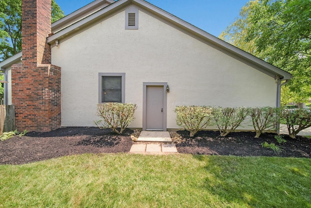 6978 Ernest Way, Dublin, OH 43017 - back of property featuring stucco siding, a yard, and a chimney