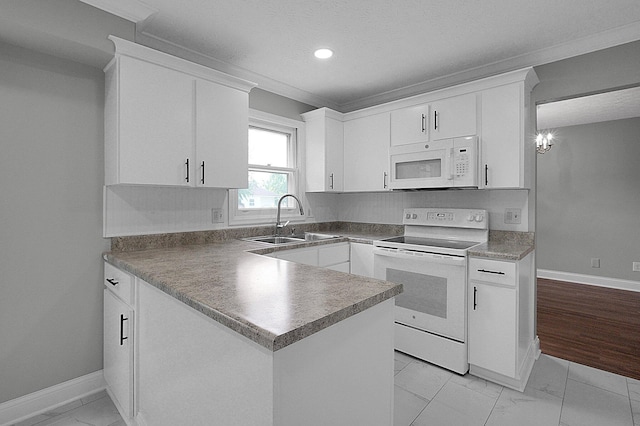 2709 Patrick Ave, Columbus, OH 43231 - kitchen with white appliances, light marble finish floors, white cabinetry, a peninsula, and recessed lighting