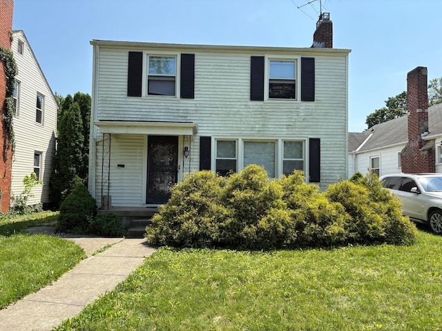 1121 E 19th Ave, Columbus, OH 43211 - traditional-style home featuring a front lawn and a chimney