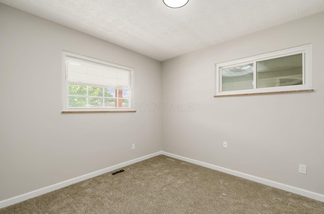 4965 Pennhurst Ave, Columbus, OH 43228 - spare room featuring carpet and a textured ceiling