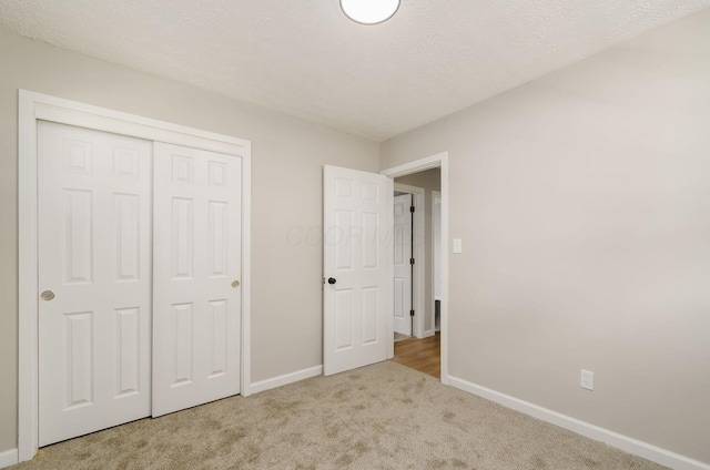 4965 Pennhurst Ave, Columbus, OH 43228 - unfurnished bedroom featuring carpet floors, a closet, and a textured ceiling