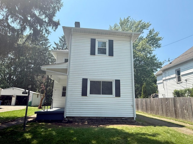 85 Blymer St, Delaware, OH 43015 - back of house featuring a chimney and an outbuilding
