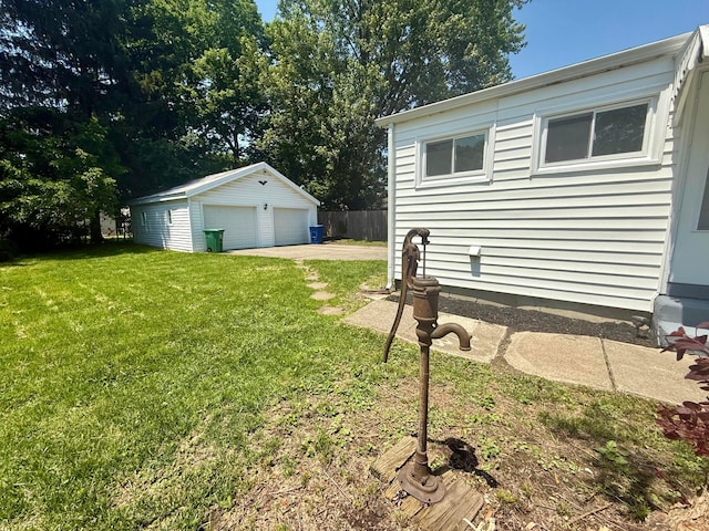 85 Blymer St, Delaware, OH 43015 - view of grassy yard with a detached garage and an outbuilding