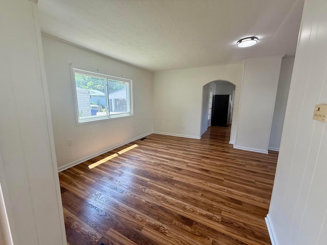 85 Blymer St, Delaware, OH 43015 - spare room with arched walkways, dark wood-style flooring, and a textured ceiling