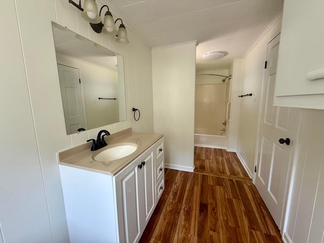 85 Blymer St, Delaware, OH 43015 - bathroom with vanity, wood finished floors, washtub / shower combination, and ornamental molding