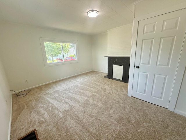 85 Blymer St, Delaware, OH 43015 - unfurnished living room with carpet floors and a fireplace with flush hearth