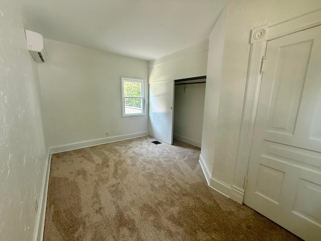 85 Blymer St, Delaware, OH 43015 - unfurnished bedroom with a wall mounted AC, carpet flooring, and a closet