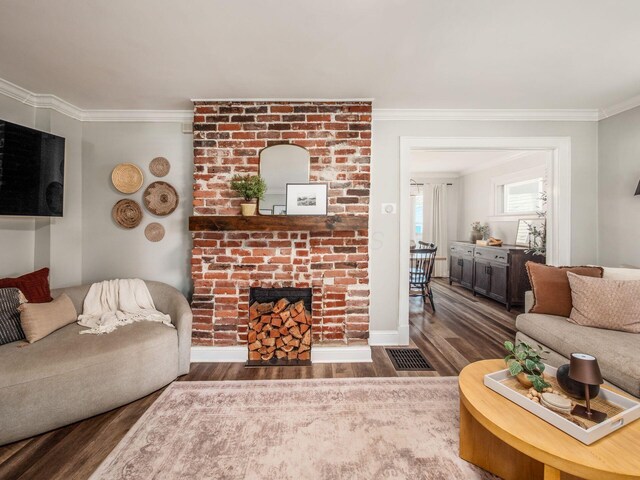 185 Frebis Ave, Columbus, OH 43206 - living area with crown molding, wood finished floors, and a brick fireplace