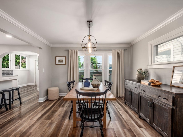 185 Frebis Ave, Columbus, OH 43206 - dining area featuring arched walkways, plenty of natural light, dark wood-type flooring, and crown molding