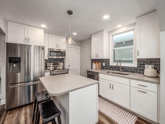 185 Frebis Ave, Columbus, OH 43206 - kitchen with appliances with stainless steel finishes, dark wood-style flooring, light countertops, white cabinetry, and recessed lighting