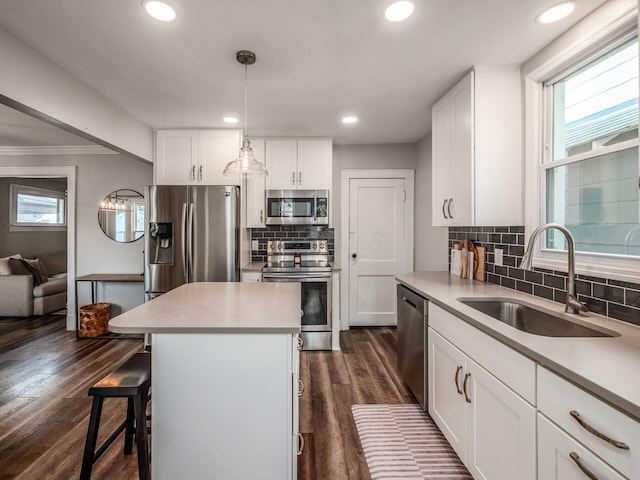 185 Frebis Ave, Columbus, OH 43206 - kitchen with stainless steel appliances, a breakfast bar area, white cabinets, decorative backsplash, and light countertops