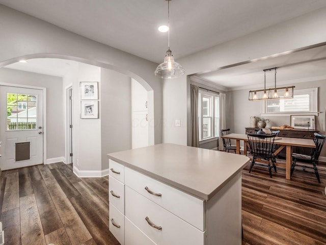 185 Frebis Ave, Columbus, OH 43206 - kitchen featuring arched walkways, dark wood finished floors, white cabinetry, and recessed lighting