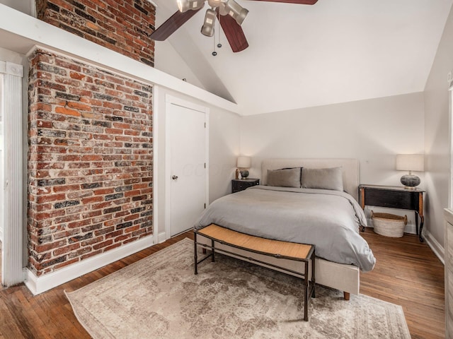 185 Frebis Ave, Columbus, OH 43206 - bedroom featuring lofted ceiling, wood finished floors, a ceiling fan, and brick wall