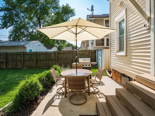 185 Frebis Ave, Columbus, OH 43206 - fenced backyard with a storage shed, outdoor dining space, area for grilling, and a patio
