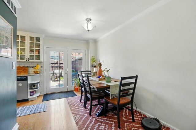 602 Dlyn St Unit H8, Columbus, OH 43228 - dining space with french doors, ornamental molding, and wood finished floors