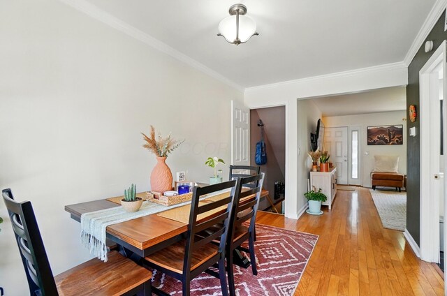 602 Dlyn St Unit H8, Columbus, OH 43228 - dining area featuring ornamental molding and light wood finished floors