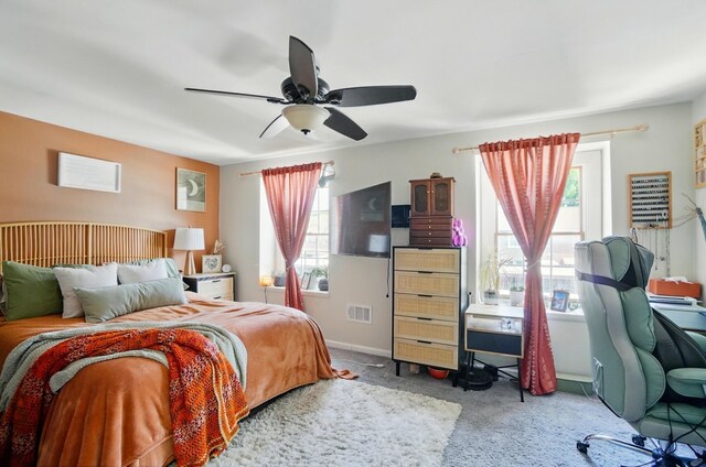 602 Dlyn St Unit H8, Columbus, OH 43228 - carpeted bedroom featuring multiple windows, ceiling fan, and a desk