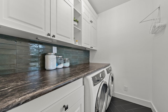 5431 Goose Falls Dr, Dublin, OH 43016 - laundry room featuring washer and dryer, cabinet space, and dark tile patterned flooring