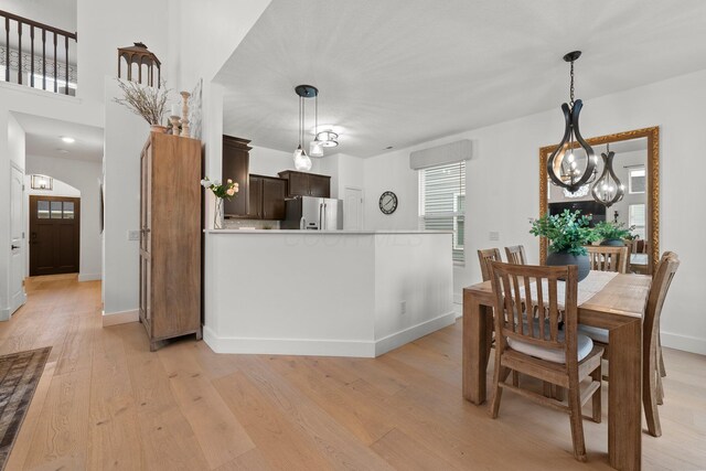 5431 Goose Falls Dr, Dublin, OH 43016 - dining room featuring light wood-style flooring and a chandelier