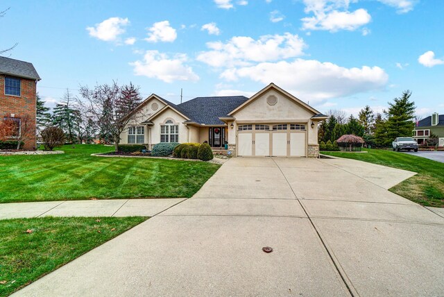 2474 Marthas Wood, Grove City, OH 43123 - view of front of home with driveway, stucco siding, a front lawn, a garage, and stone siding